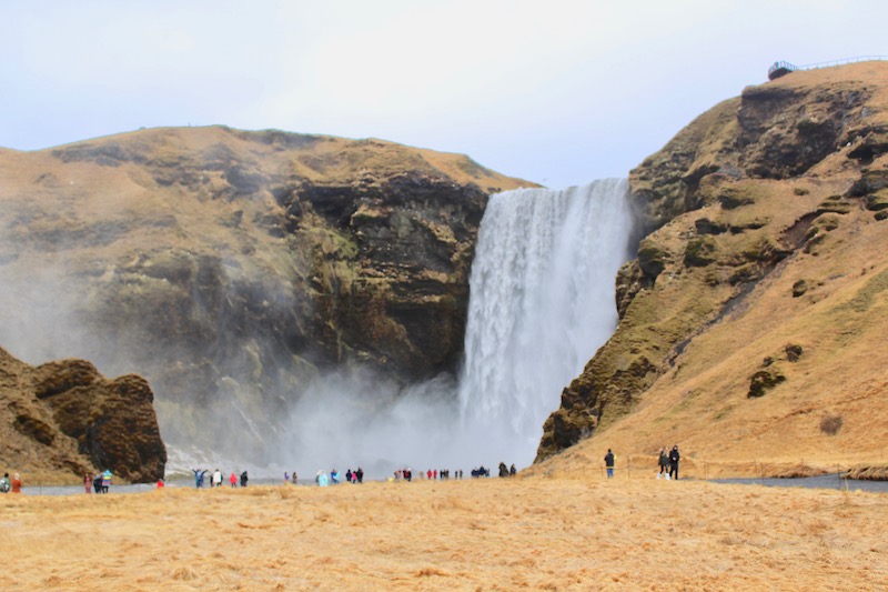 The enormous Skogafoss creates a huge cloud of mist